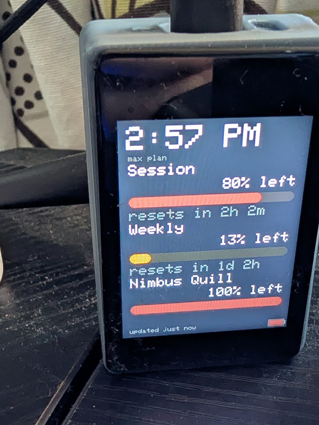 Yoyu on a desk, showing labelled session and weekly usage
           meters with the percentage left in each.